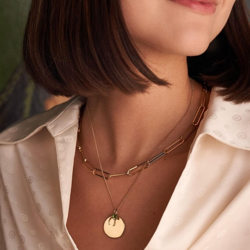 Jewelery layered on neck