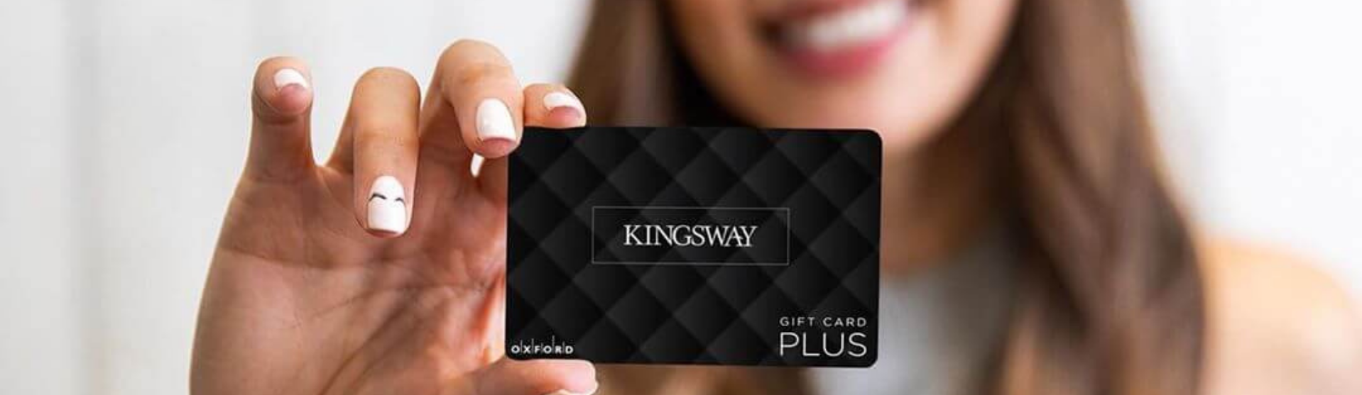 Woman holding up a gift card