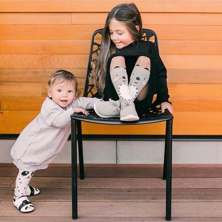 two kids hanging out in trendy clothes