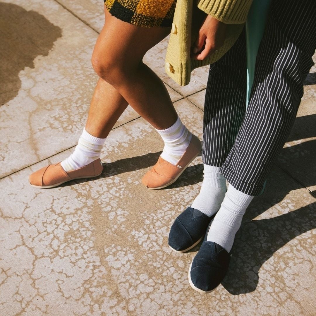 Brown and black TOMS shoes