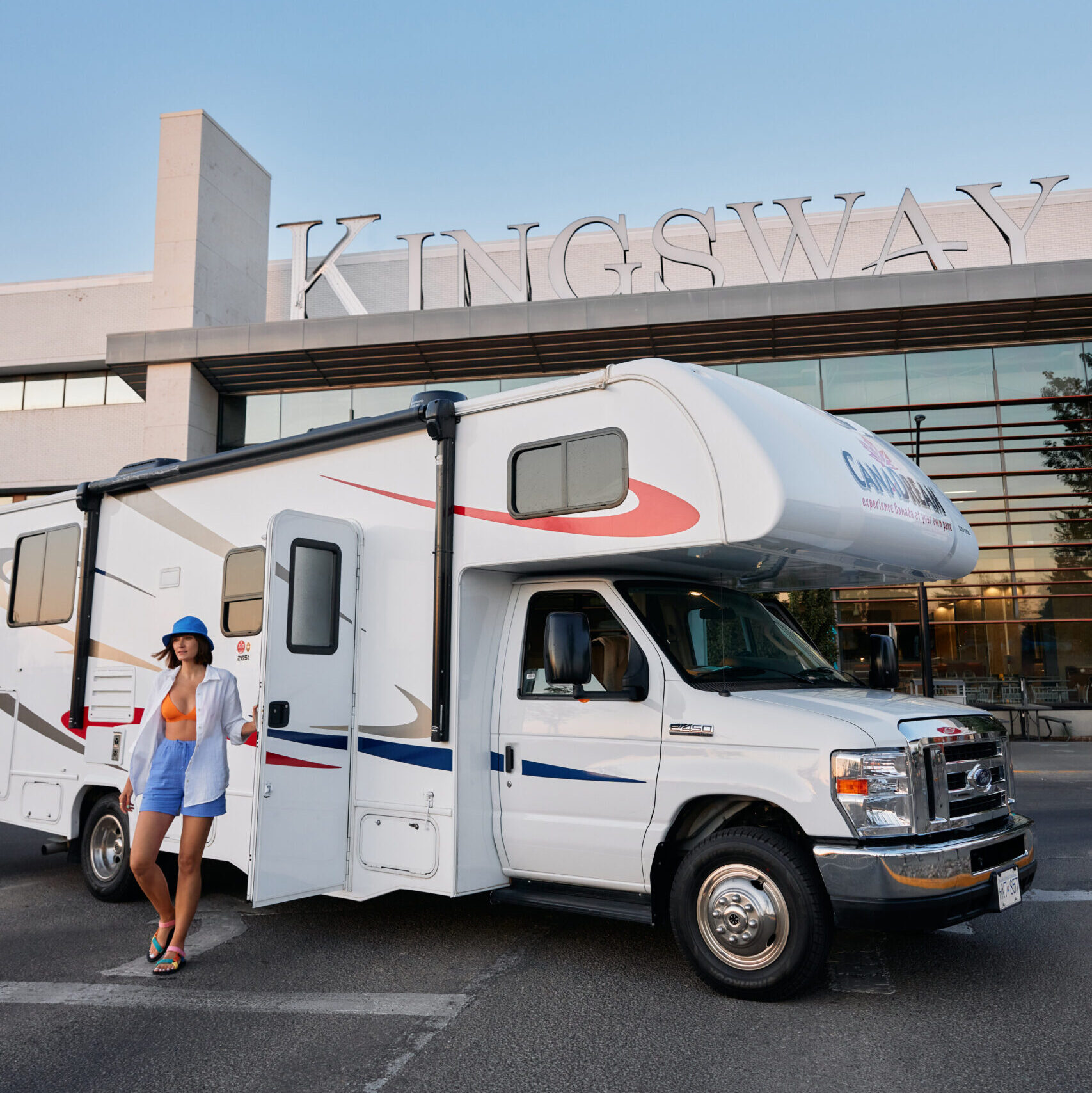 Girl in front of Kingsway with an RV